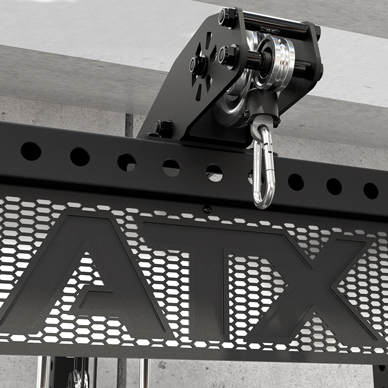 Close-up of the ATX® Power Cage with Cables, a black metal rack featuring a perforated panel and pulley system on the top frame, set against a concrete wall and ceiling.