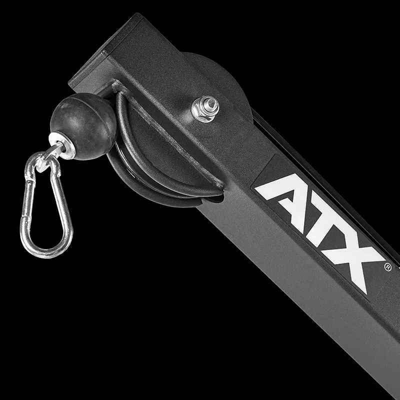 Close-up of a black ATX® Cable Lat Pull Down Machine part, showing the cable, pulley, and carabiner clip. The white ATX® logo appears on the frame against a solid black background.