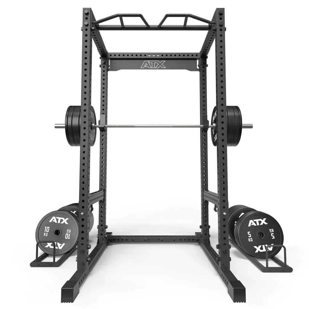 The ATX® Power Rack 780 is a black rack featuring a pull-up bar, loaded barbell, and weight plates (5 kg to 20 kg). It has a sturdy perforated frame for adjustable height settings, suitable for various exercises.