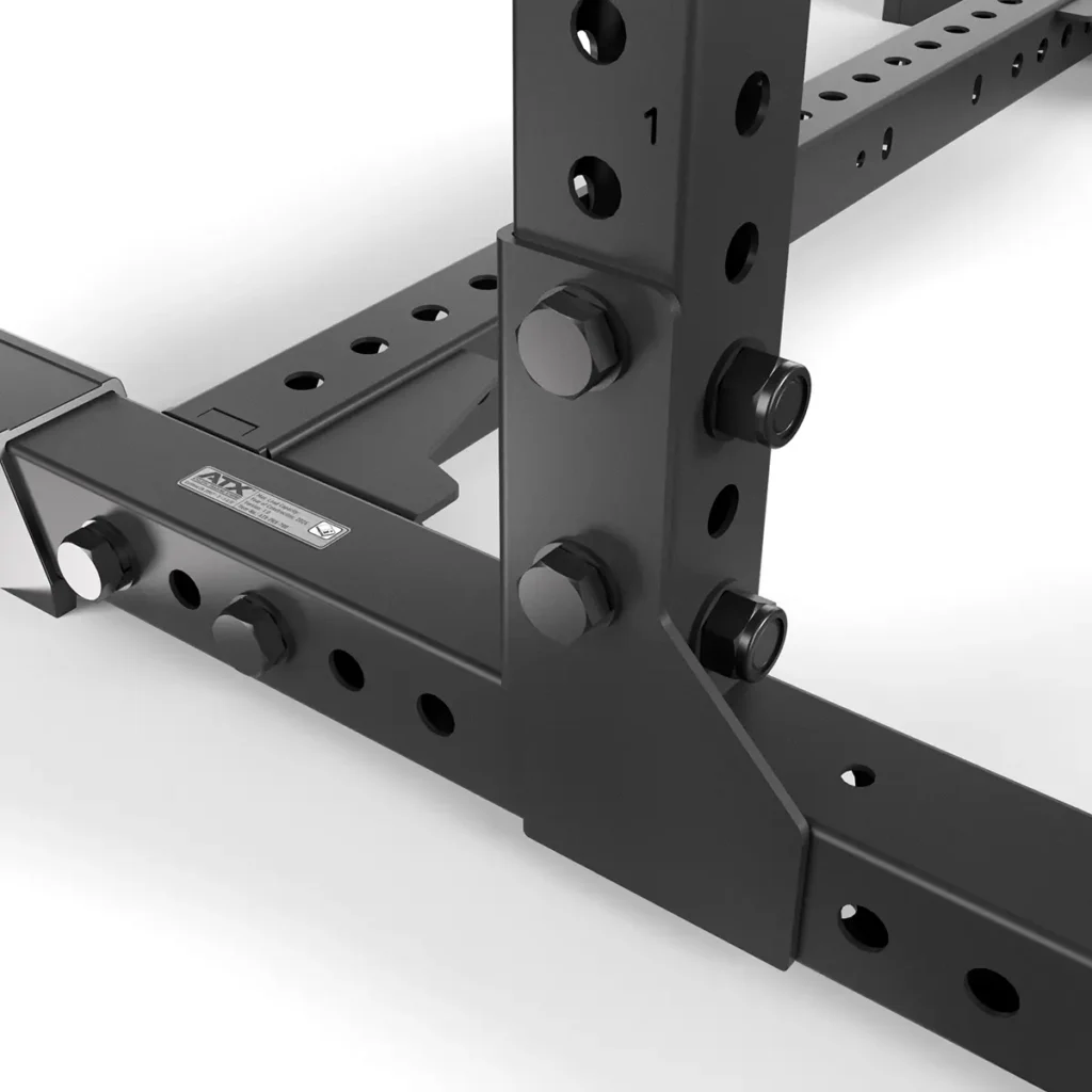 Close-up of the ATX® Power Rack 780s black metal corner, showcasing robust bolts and a perforated design for adjustable fittings against a white background.