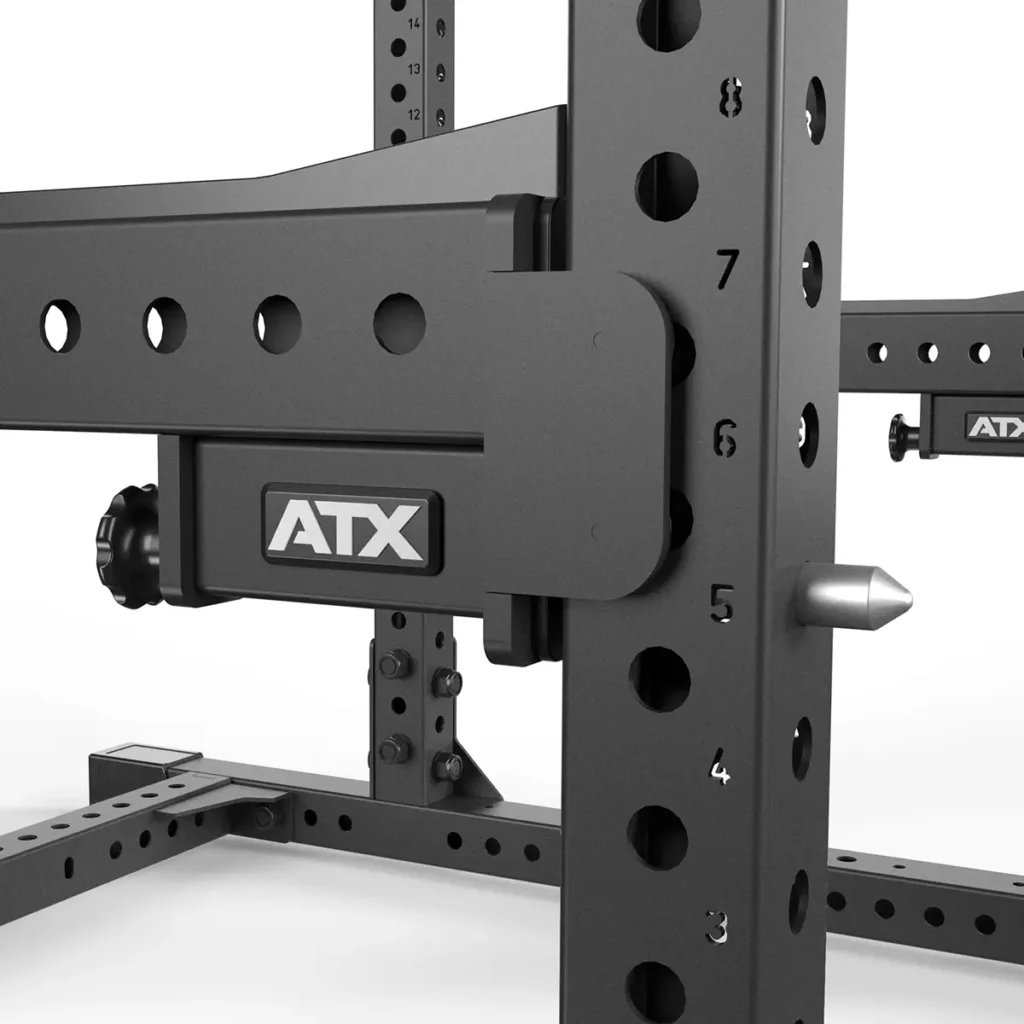 Close-up of the ATX® Power Rack 780 in black with adjustable, numbered holes from 3 to 7. Its sturdy metal build features a logo and various slots for customization and secure placement of gym equipment.