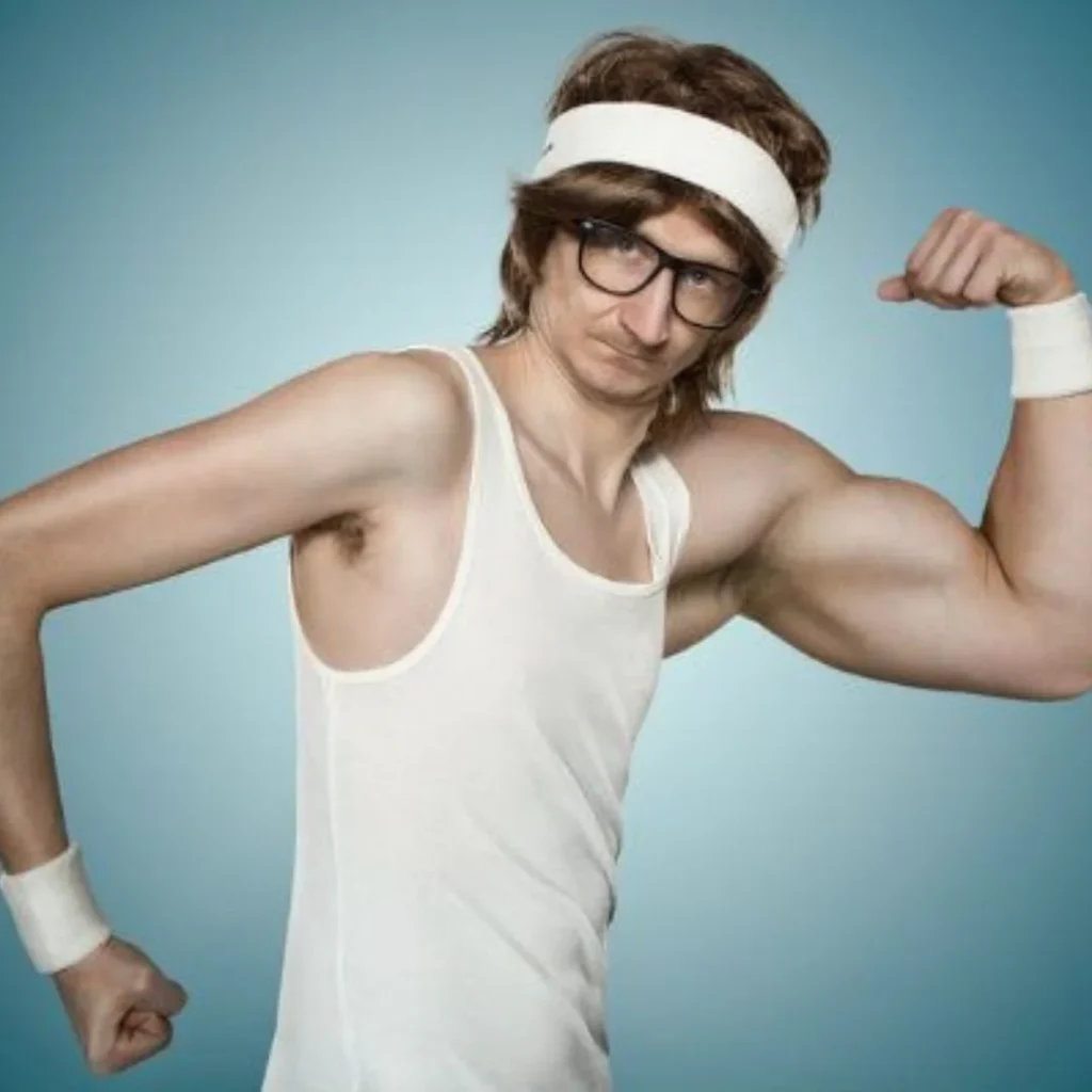 A person in a white tank top and headband flexes their bicep against a blue background. They wear glasses and have wristbands on both wrists.