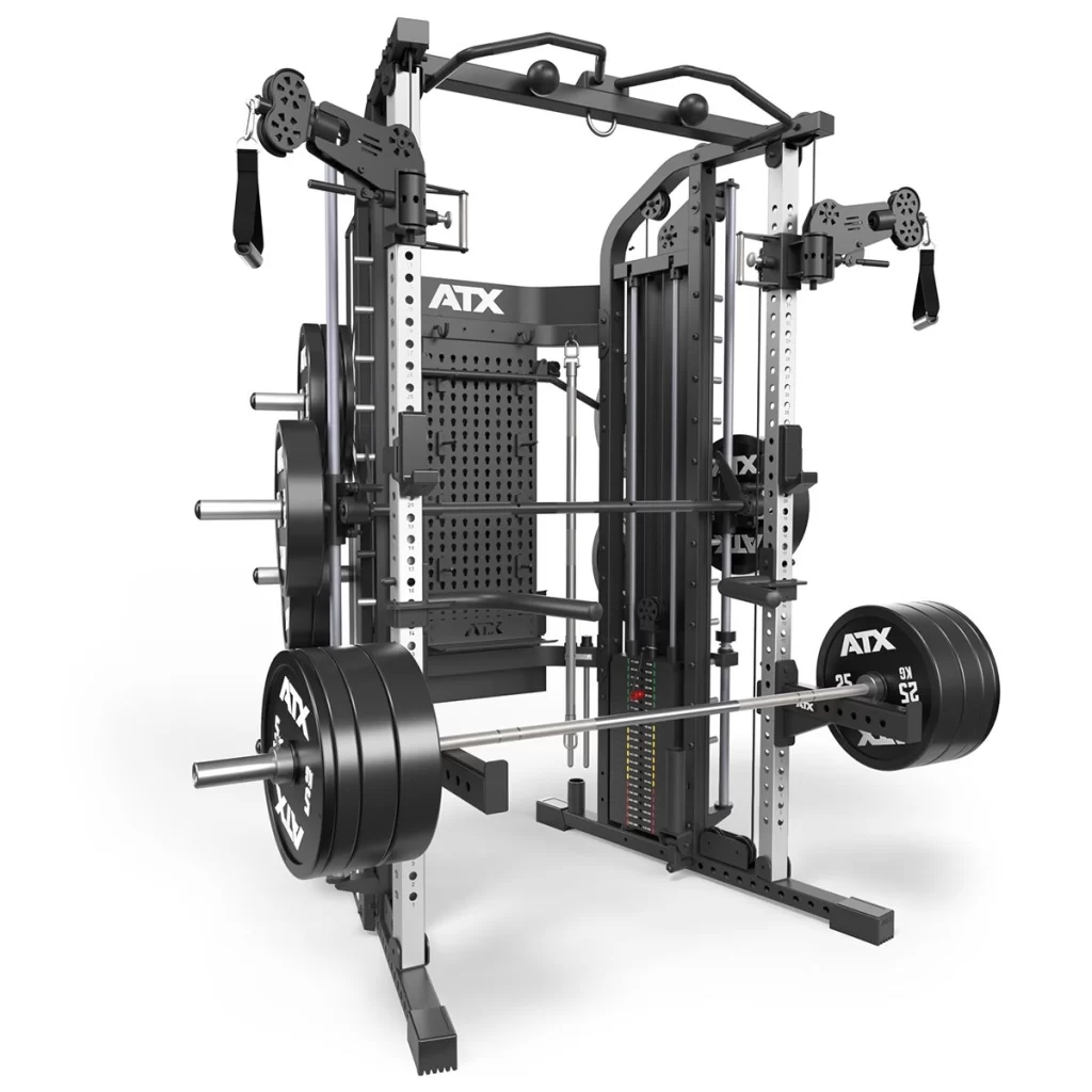 The ATX® Monster 2.0 All In One Trainer is a multi-functional gym station with attachments like a barbell, weights, pulleys, and weight racks for strength training, featuring a sleek black and gray design.