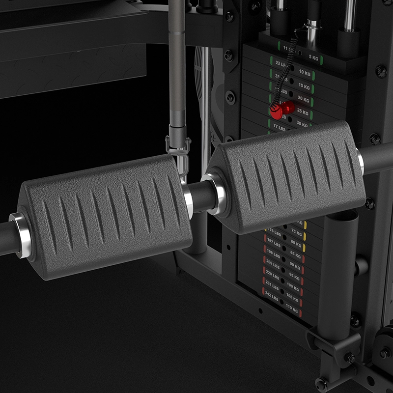 Close-up of the ATX® Monster 2.0 All In One Trainer, showcasing two textured black foam rollers on a metal bar, with a weight stack and resistance adjustment pin visible in the background.