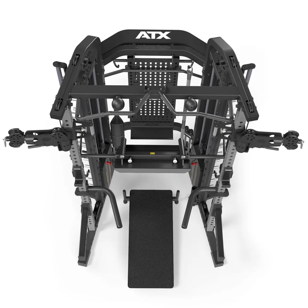 Top view of the ATX® Monster 2.0 All In One Trainer, a black, multi-functional unit with attachments and handles for strength training. Includes a pull-up bar, weight stack, adjustable bench, and cable attachments for varied workouts.