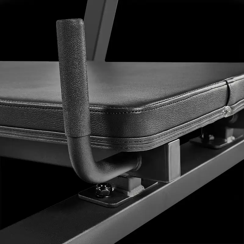 Close-up of the ATX® Vertical Leg Press, featuring a padded bench with a textured metal handle, attached to a sturdy black frame, designed for vertical leg presses, set against a plain black background.