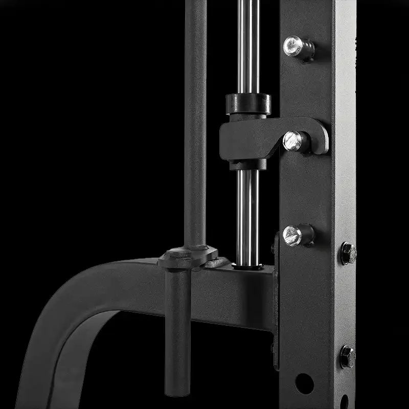 Close-up of the ATX® Vertical Leg Press's black metal frame with bolts, rods, and a guide rail, shown against a plain black background.
