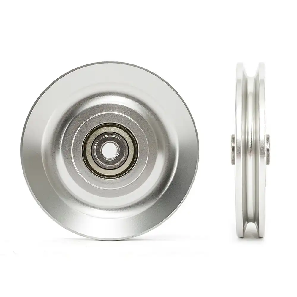 A silver metal roller with a central bearing is shown from two angles. The left image displays the roller front-on, highlighting the circular bearing. The right image shows the roller from the side, emphasizing its thin, circular profile.