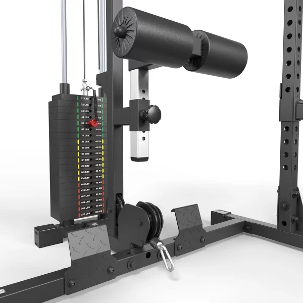 Close-up of a gym machine component with black padded rollers, adjustable weight stacks labeled in various kilograms, cables, and metallic footplates. The machine appears sturdy, designed for strength training exercises.