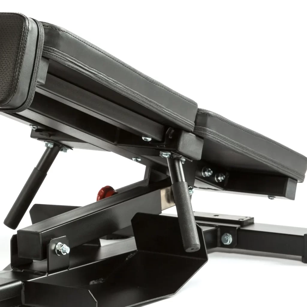 Close-up view of the ATX Torso Trainer, a black adjustable bench with a padded seat, sturdy metal frame, adjustment handles, and bolts, set against a plain white background.