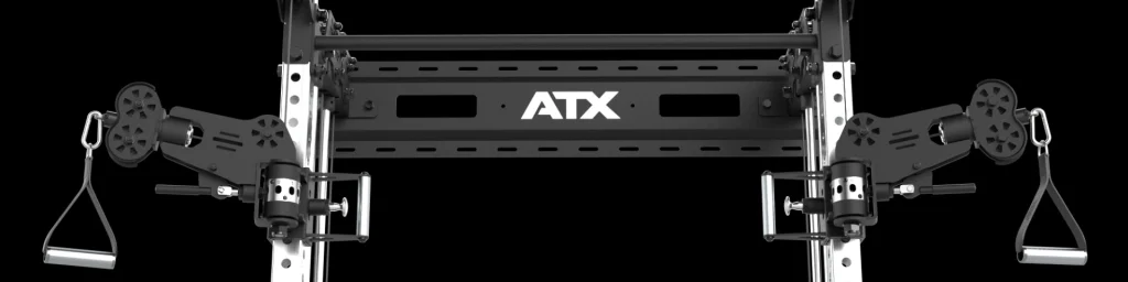 Close-up of the ATX Half Rack with Cable Crossover, a black and silver gym power rack featuring adjustable pulleys and handles on each side, set against a black background.