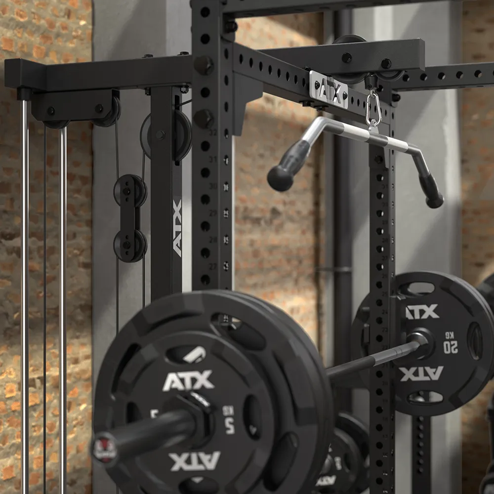 Black 640 Low Ceiling + Plate Load Lat Option power rack with a lat pulldown attachment and weight plates loaded on the barbell.