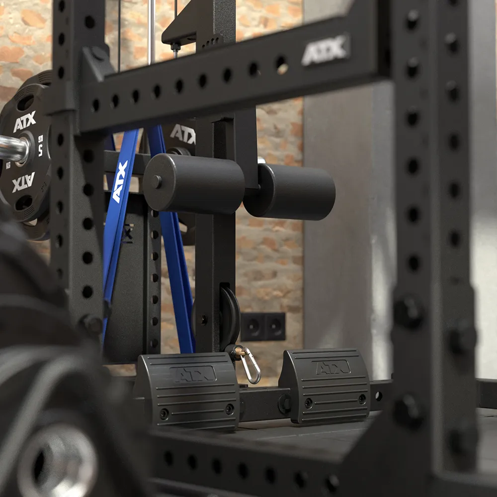 Black metal 640 Low Ceiling + Plate Load Lat Option power rack featuring a lat pulldown station with blue cables, foam thigh pads, and foot plates.