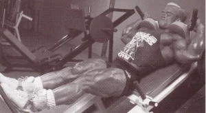 Lee Priest on a hack squat machine doing an exercise