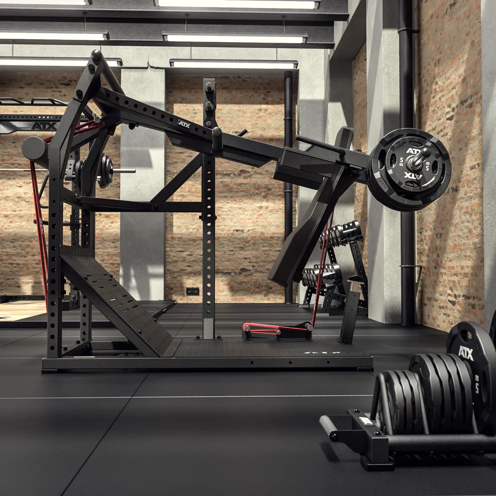 Modern gym with brick walls featuring an ATX® Pendulum Squat Machine loaded with weights, additional weight plates stacked on the floor, large windows for natural light, and polished black flooring.