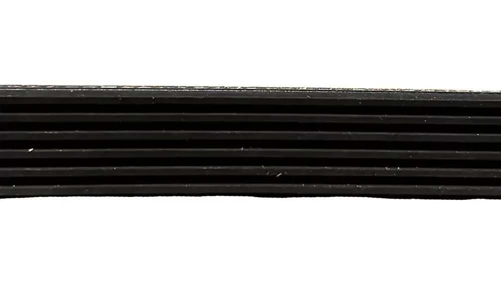 Close-up of the edge of the Drive Belt PJ1244-6ribs, a black, multi-ribbed automotive belt featuring a detailed grooved texture against a white background.