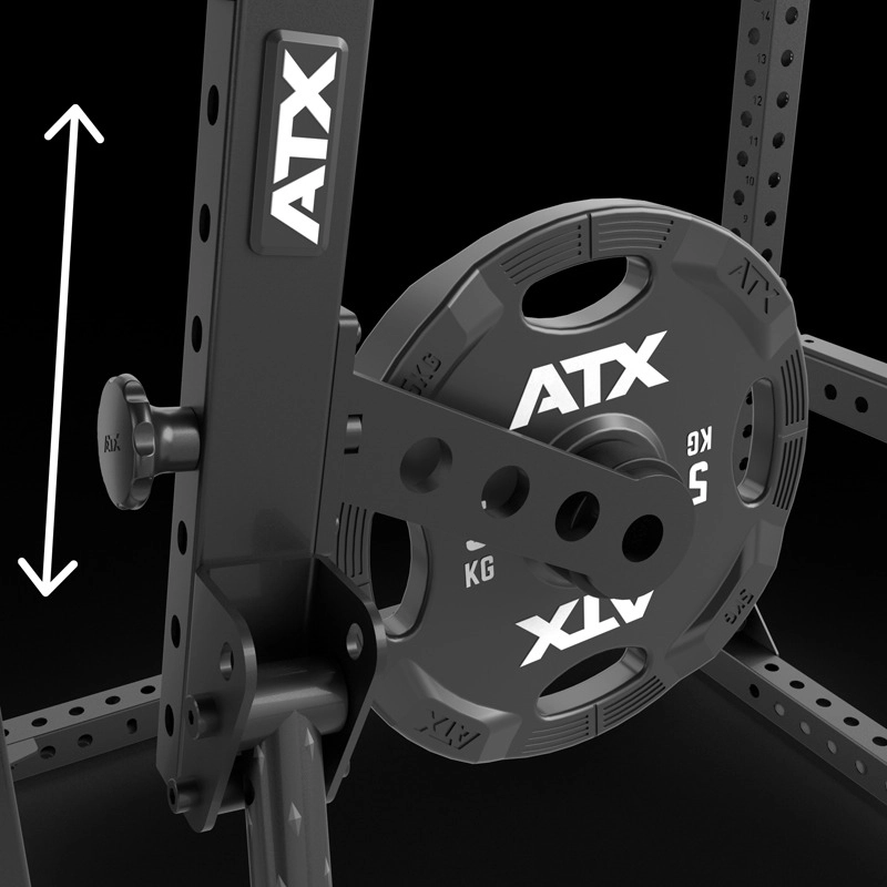 Close-up of a black ATX weight plate mounted on adjustable gym equipment, with a white double-headed arrow indicating vertical movement. The equipment features multiple adjustment holes and visible ATX branding.