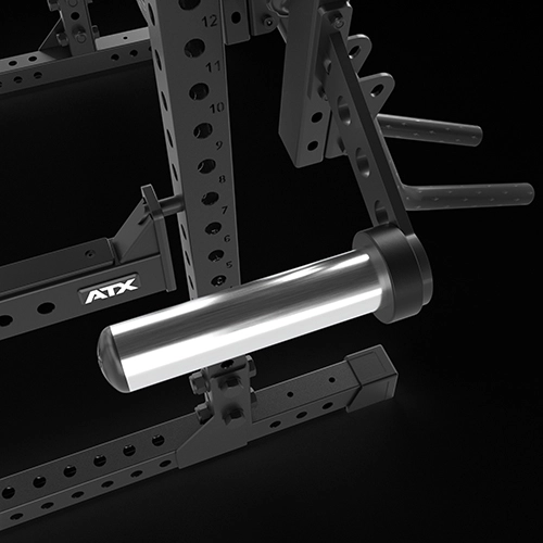 Close-up of a black metal gym rack with an attached cylindrical weight storage holder, displaying the ATX logo. The image highlights the rack’s numbered holes and sturdy construction.