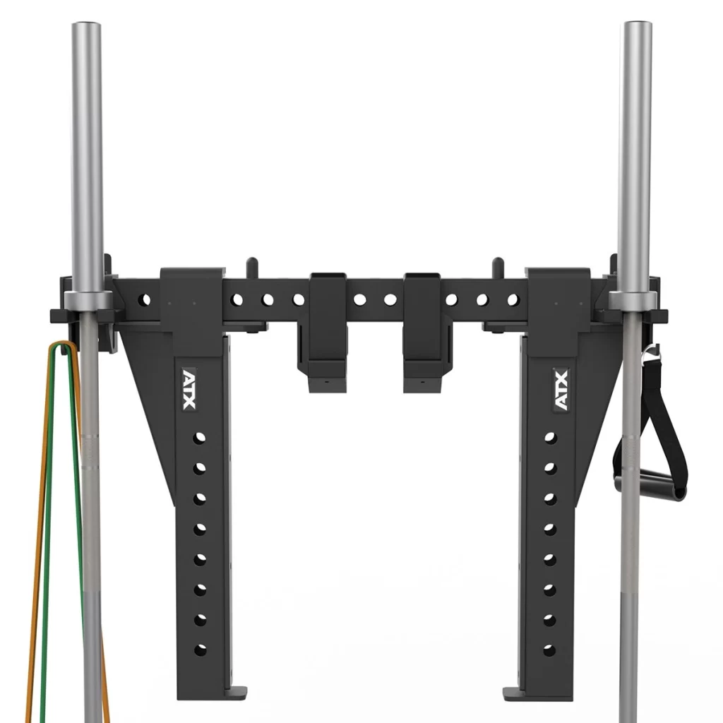 Black adjustable squat rack attachment with two vertical arms, silver bar holders, resistance bands on the left, and a strap handle on the right. The brand ATX is visible on both vertical arms.
