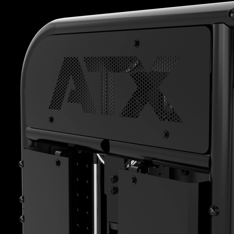 Close-up of a black metal panel with the letters ATX cut out in a mesh pattern, likely part of a piece of gym equipment or machinery, against a black background.