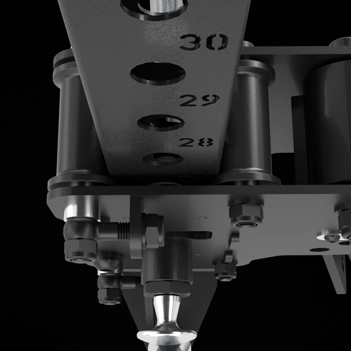 Close-up of a black metal machine part with circular holes labeled 28, 29, and 30, bolts, and cylindrical components, against a black background.