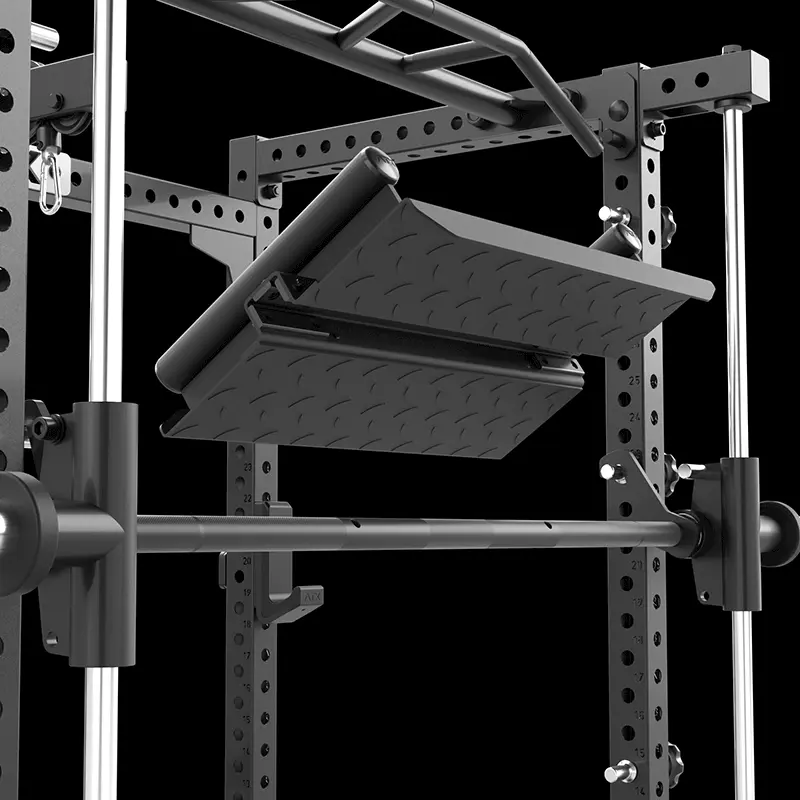 Close-up view of a black metal gym power rack with an attached adjustable footplate and pull-up bar, isolated on a solid black background.