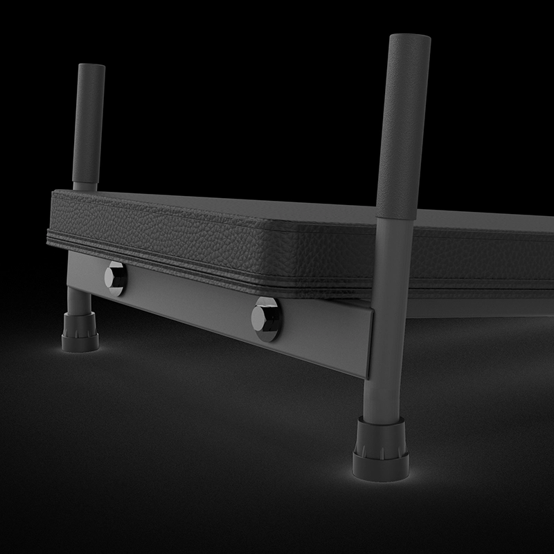 A close-up view of a black metal and padded platform with two vertical handles and adjustable feet, set against a dark background.