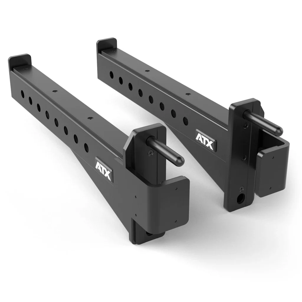 Two black metal squat rack safety arms with multiple adjustment holes, cylindrical pegs for attachment, and the ATX logo printed on the side. The arms are positioned parallel to each other on a white background.