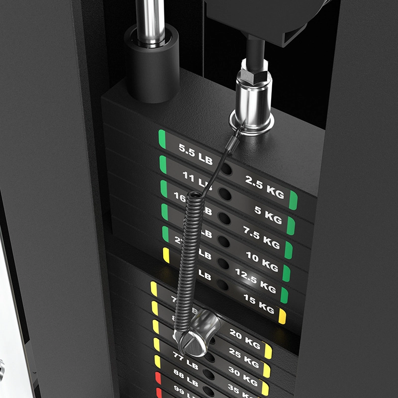 Close-up of the ATX® Single Cable Station - Wall Mounted (Copy) weight stack with a metal pin selector and coiled safety cable. Weight plates have color-coded labels, marked in both pounds and kilograms.