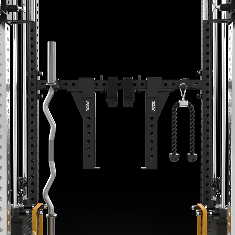 A close-up of a gym power rack with attachments, including a curved barbell on the left, black adjustable safety arms, and a black tricep rope attachment on the right, set against a black background.