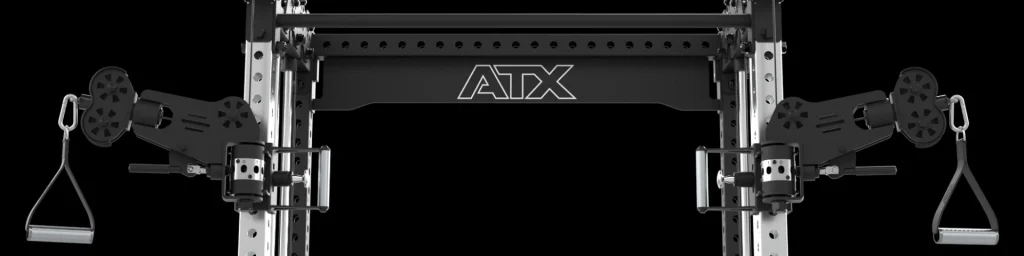 Close-up view of a black and silver ATX cable crossover machine with adjustable pulleys and two handles, set against a black background.