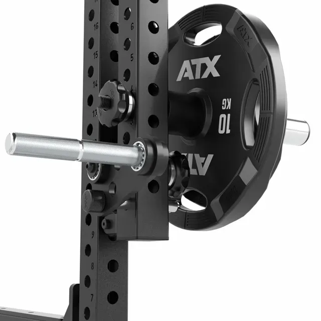 Close-up of a black ATX 10 kg weight plate mounted on a metal storage peg attached to a gym rack with adjustable holes and bolts.