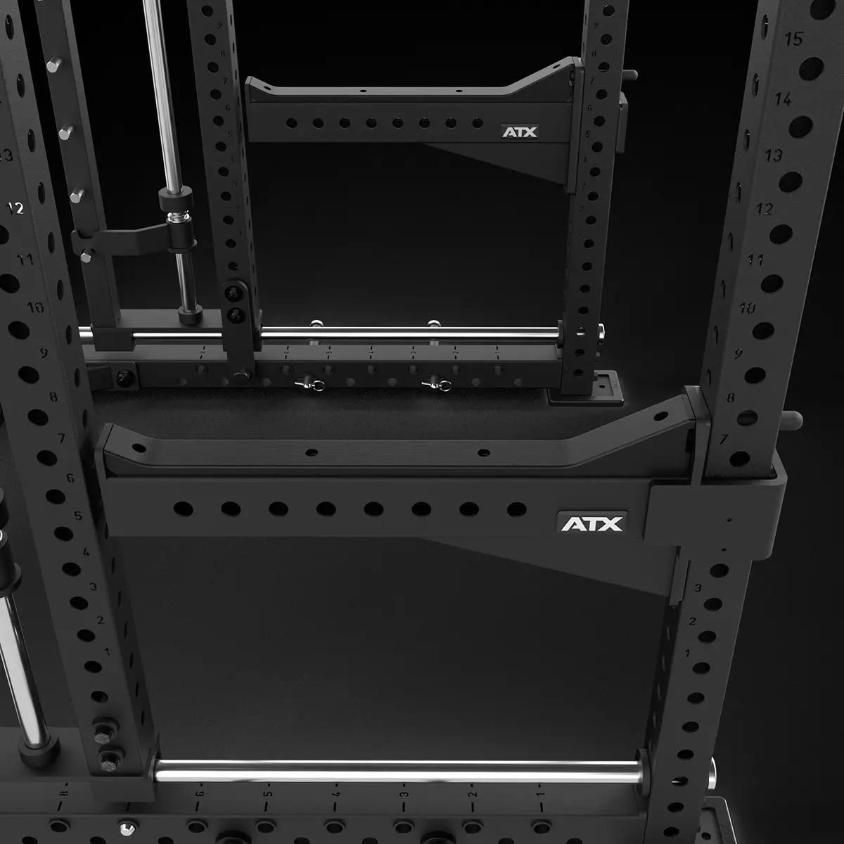 Close-up view of a black ATX power rack with multiple holes for adjustable attachments, sturdy metal construction, and safety spotter arms, set against a dark background.