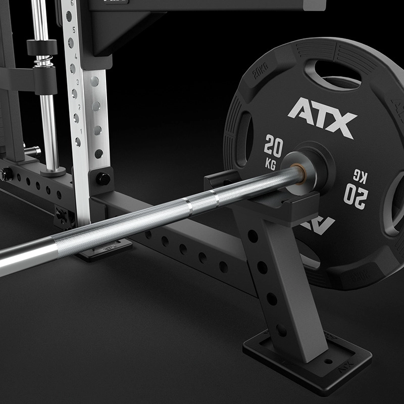 Close-up of a weightlifting barbell loaded with a 20 kg ATX weight plate, resting on a squat rack in a gym setting with a black background.