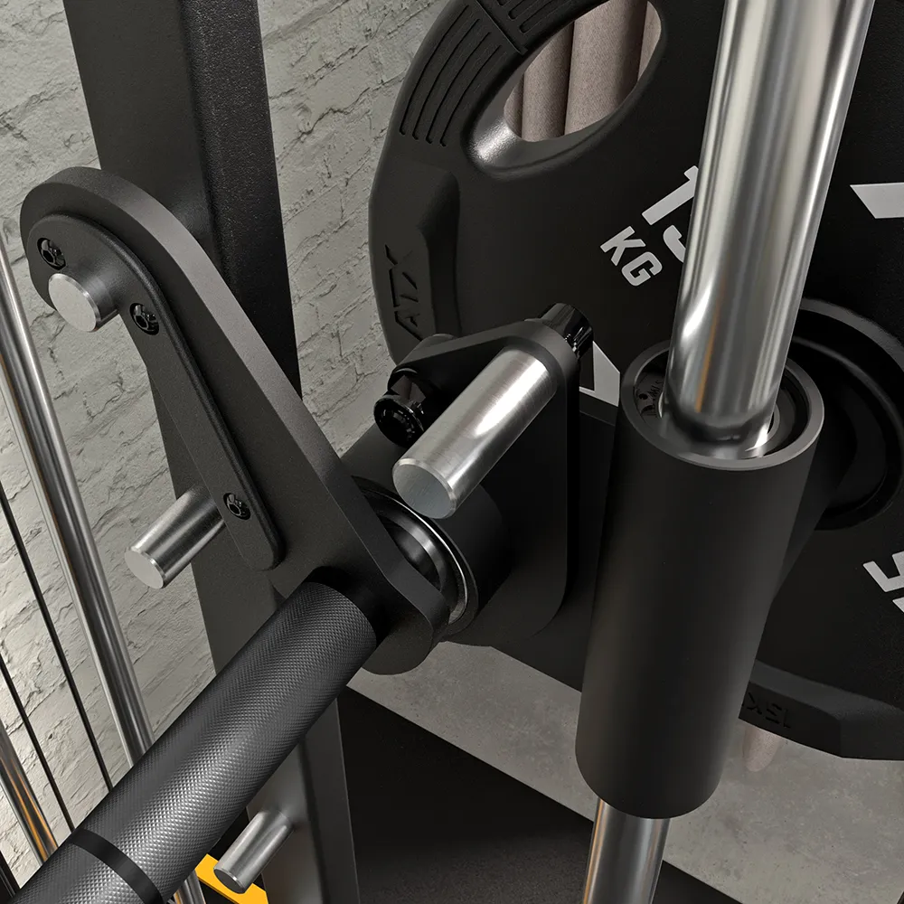 Close-up of a gym machine showing a black barbell, a weight plate labeled 15 KG, a metal safety catch, and a padded vertical support, all against a gray textured wall.
