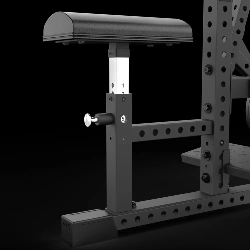 Adjustable gym equipment attachment with a padded top, metal support post marked with numbers, and a locking pin, mounted on a power rack with multiple holes for customization.