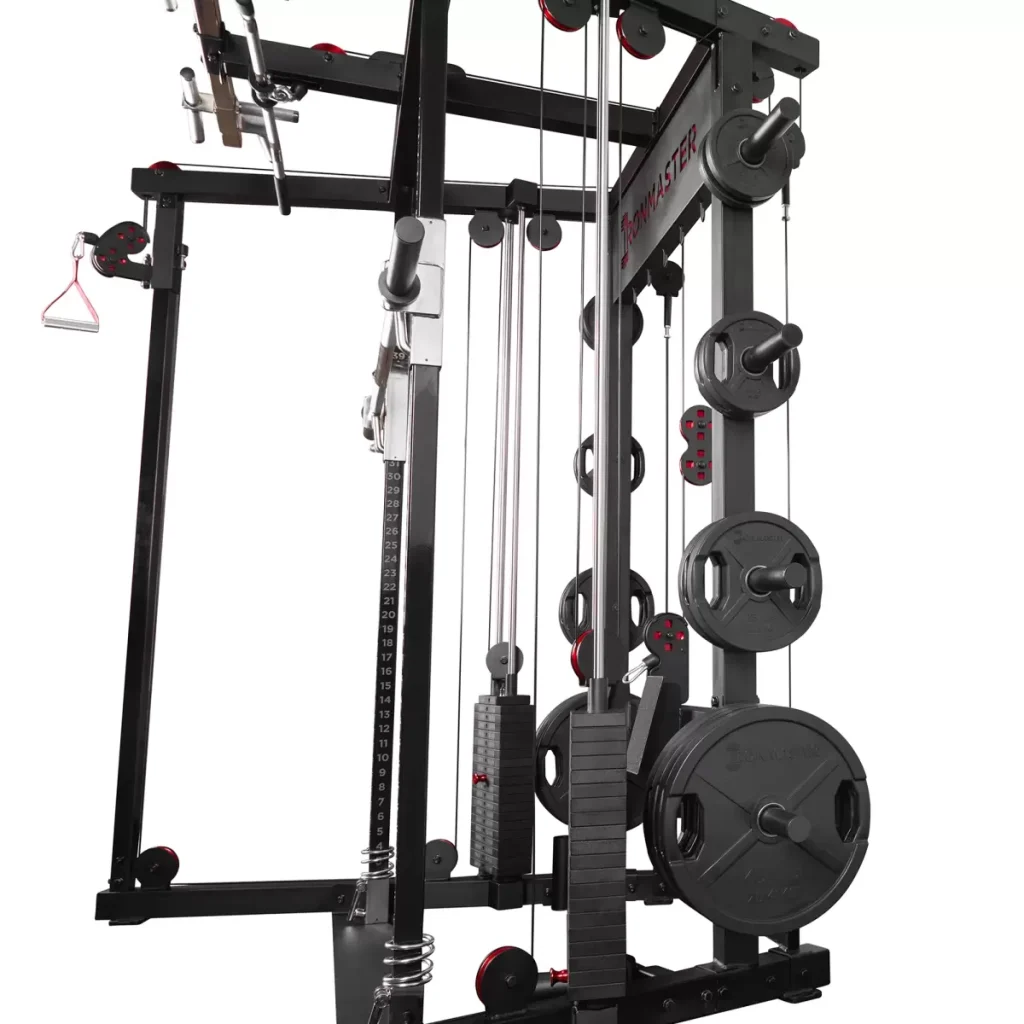 A close-up view of a multi-functional home gym machine with adjustable weight plates, pulleys, cables, and handles for strength training exercises. The equipment is black with red accents.