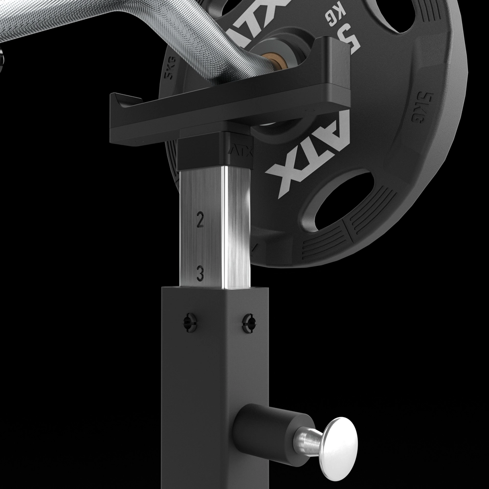 Close-up of a weightlifting bar with a 5 kg ATX plate on a squat rack near the ATX® Bicep Blaster Preacher Curl Machine (Copy). Height adjustment markings (2, 3) are visible on the metal post against a black background.