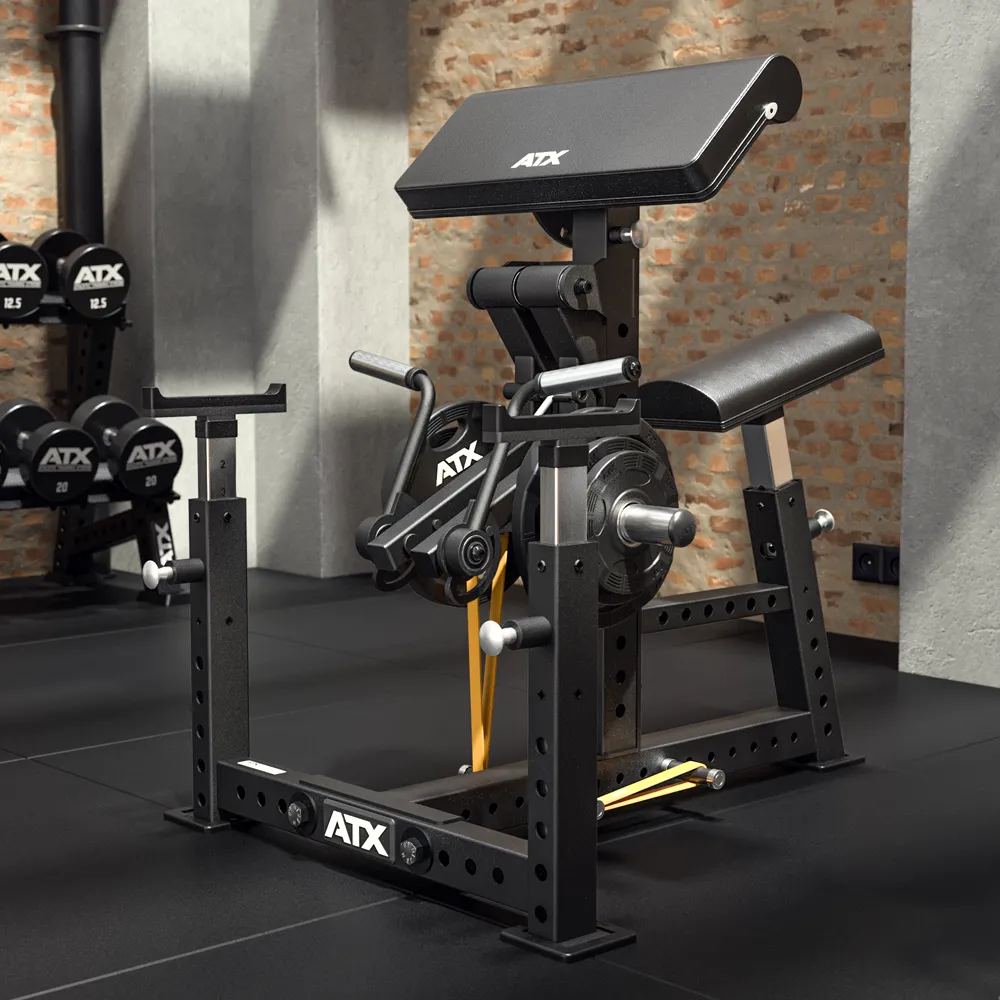 An ATX® Bicep Blaster Preacher Curl Machine (Copy) in black stands on a gym floor, featuring an adjustable padded armrest and seat. Dumbbells are stacked on racks against a brick wall in the background.