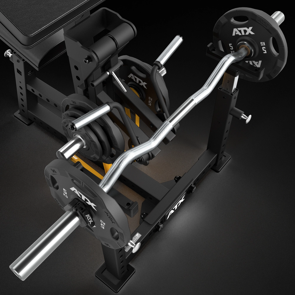 A close-up of the ATX® Bicep Blaster Preacher Curl Machine shows an EZ curl bar loaded with ATX plates, resembling a preacher curl setup. Extra plates rest on pegs attached to its sleek black frame with metallic and white accents.