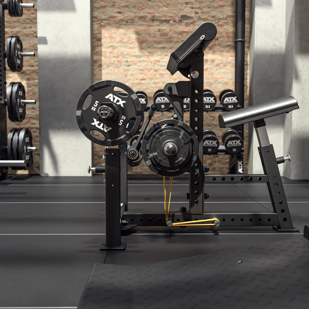 A gym featuring the ATX® Bicep Blaster Preacher Curl Machine, black strength equipment, resistance bands, wall-racked weight plates, and brick and concrete walls.