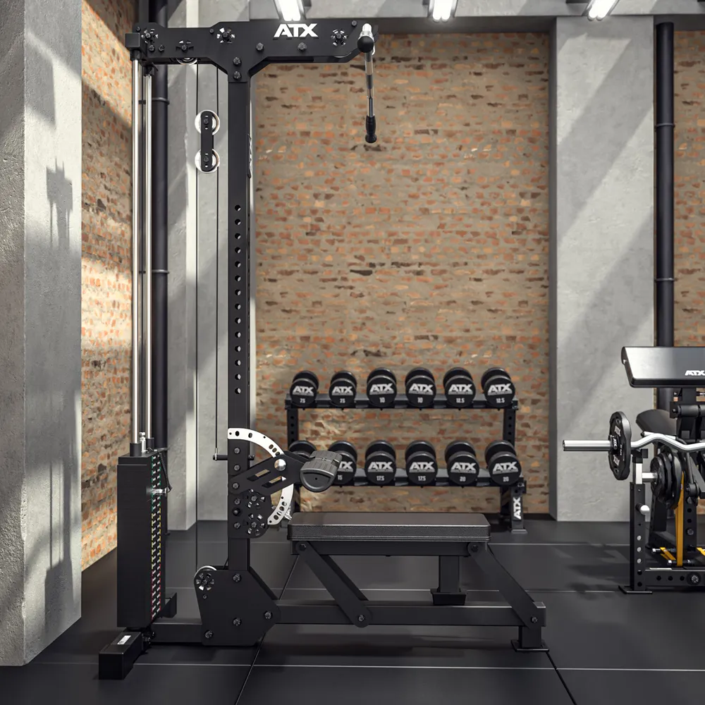 A gym with a black ATX cable machine, weight stack, adjustable bench, and a rack of dumbbells in front of a brick wall.
