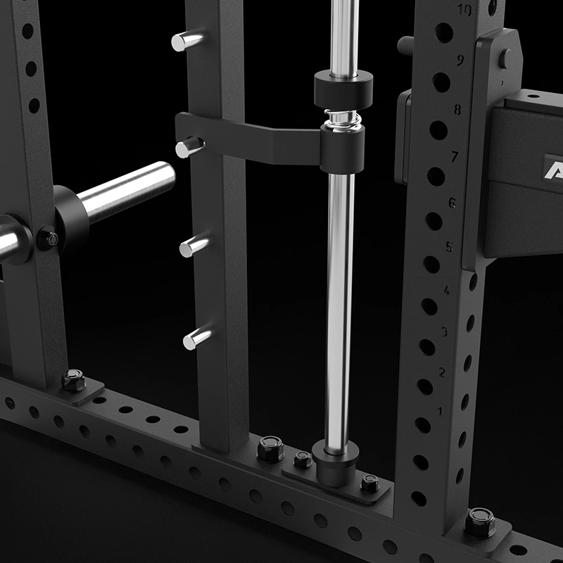 Close-up of a black metal gym rack with multiple holes, a mounted barbell, and metal pegs for adjusting height against a dark background.