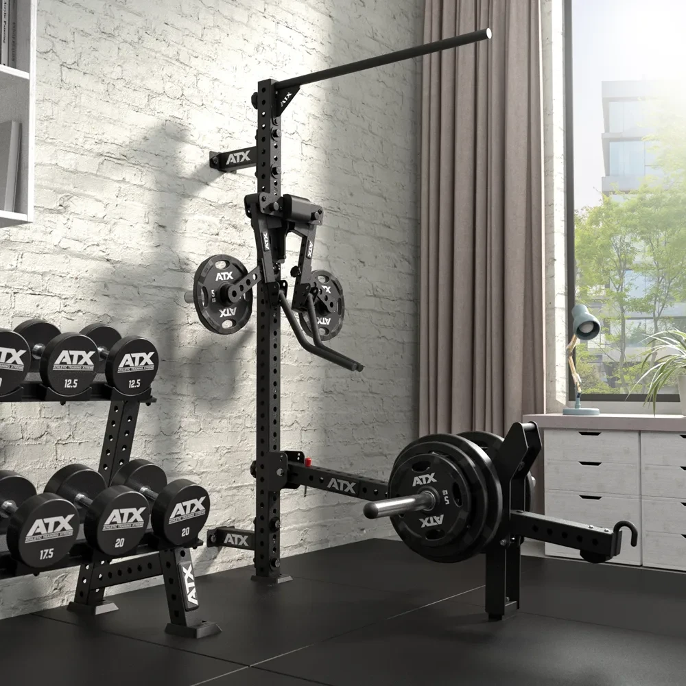 Wall-mounted ATX gym rack with a pull-up bar, a landmine attachment holding weight plates, and a rack of ATX dumbbells.