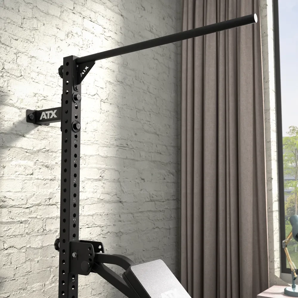 Wall-mounted black steel pull-up bar attached to a rack.