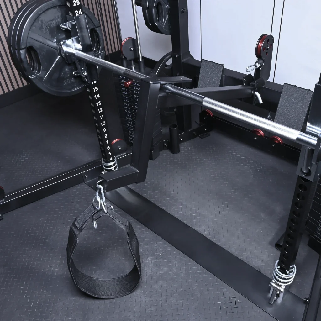 Landmine attachment with a weight plate and nylon strap handle secured to a gym power rack.